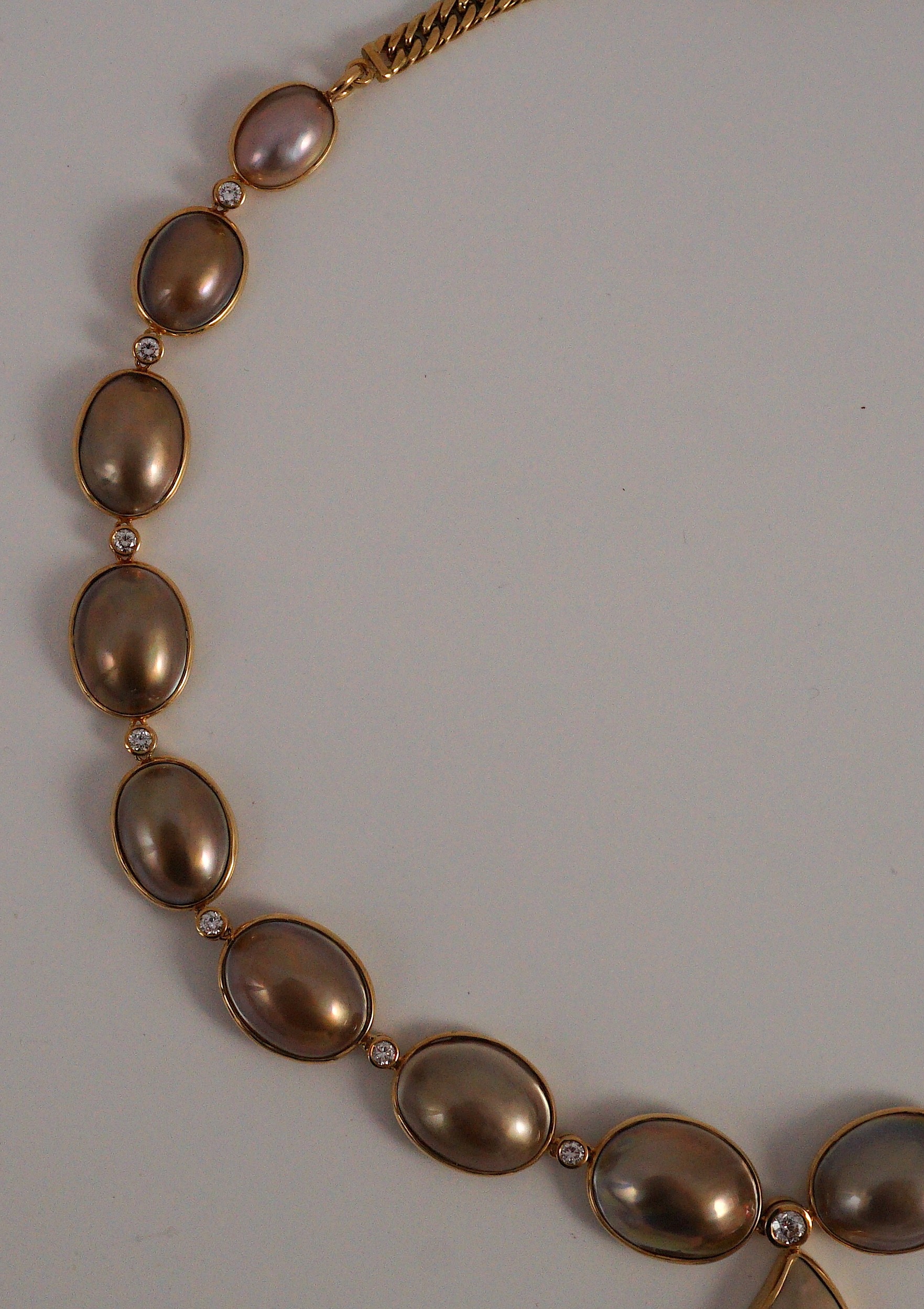 A cased modern single strand graduated shaped mabe pearl and round brilliant cut diamond set drop necklace, with 18ct gold clasp and chain section